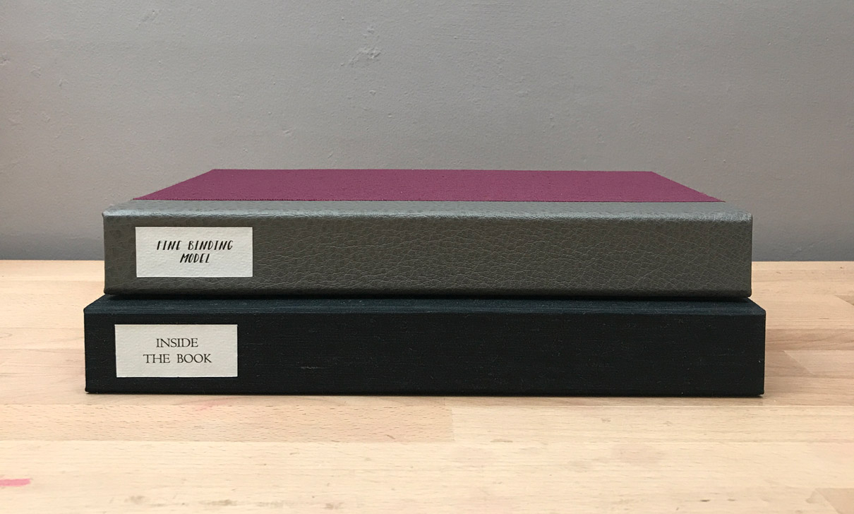 Two clamshell boxes sitting on a wooden table.