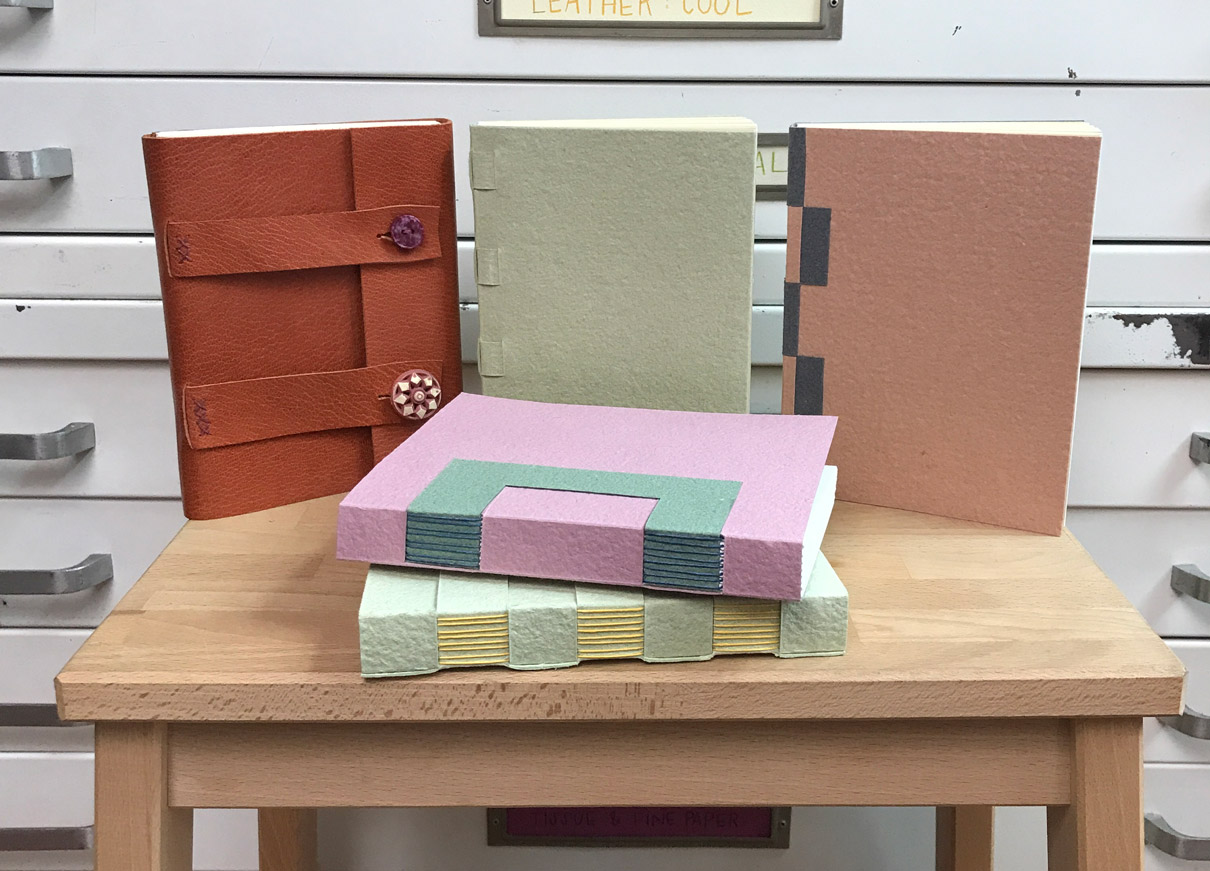 A variety of Cross Structure Bindings standing on a wooden table.