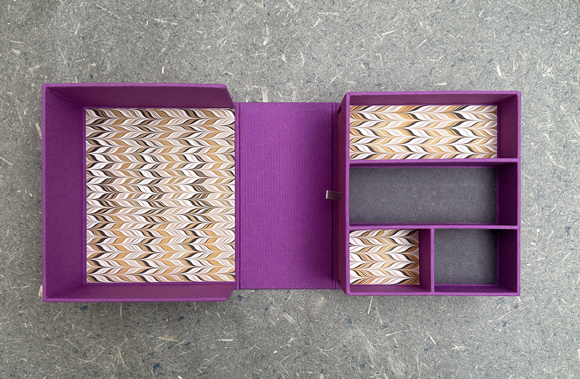 Two clamshell boxes sitting on a wooden table.
