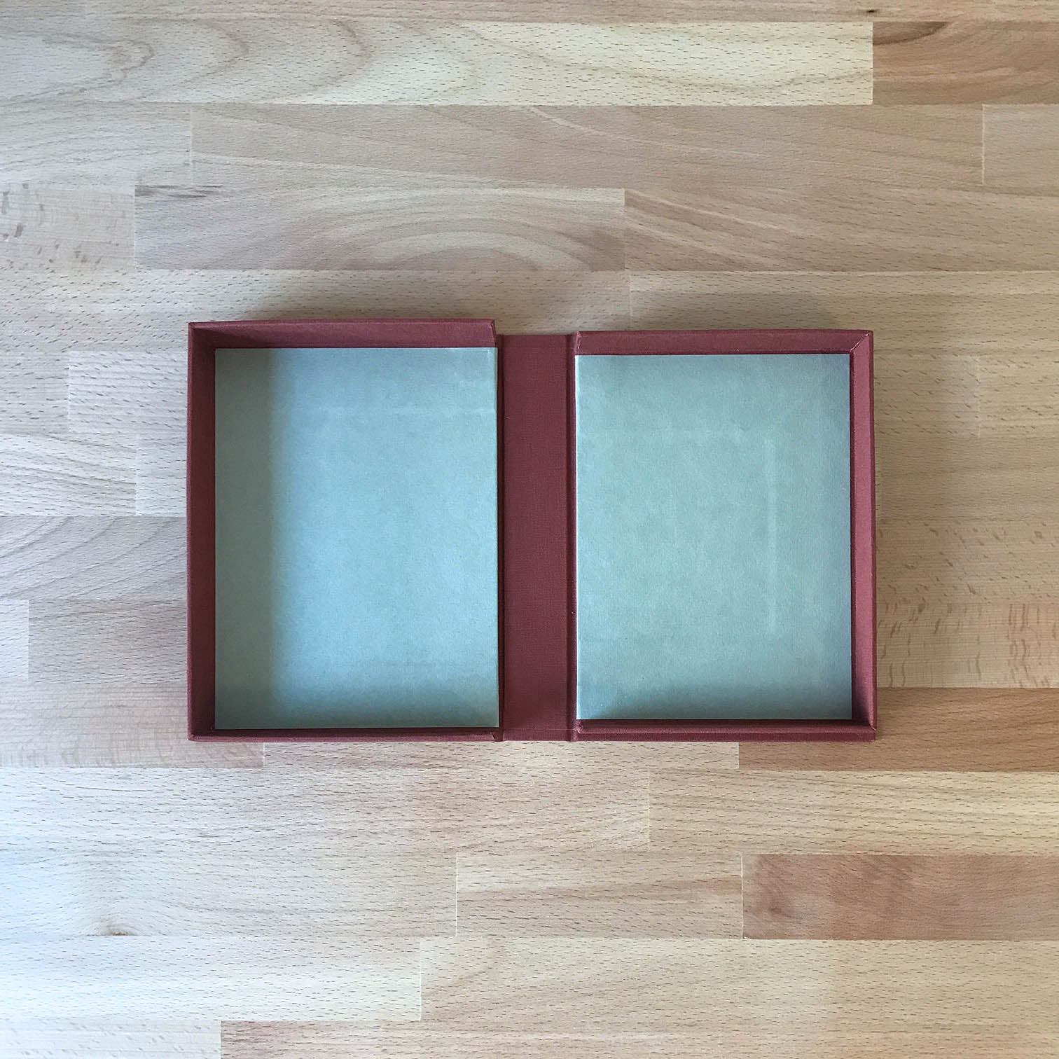 Clamshell Box sitting on a wooden table.