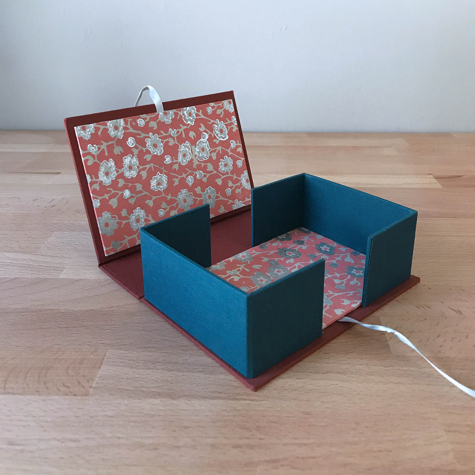 Drop Spine Box sitting on a wooden table.
