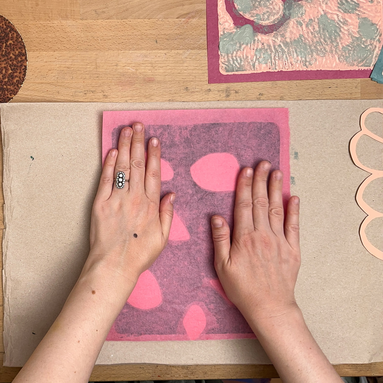 Smoothing down backside of paper ontop of Gelli plate to create monoprint.