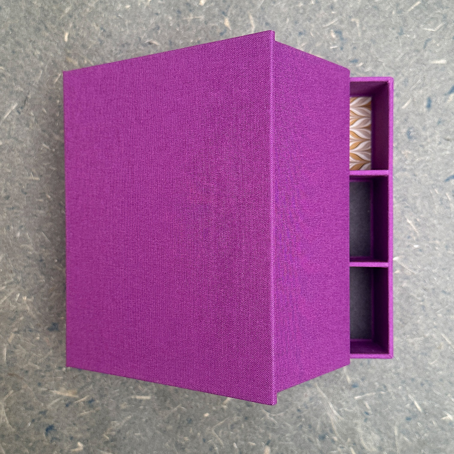 A box lid slightly open showing a hint of what's inside.