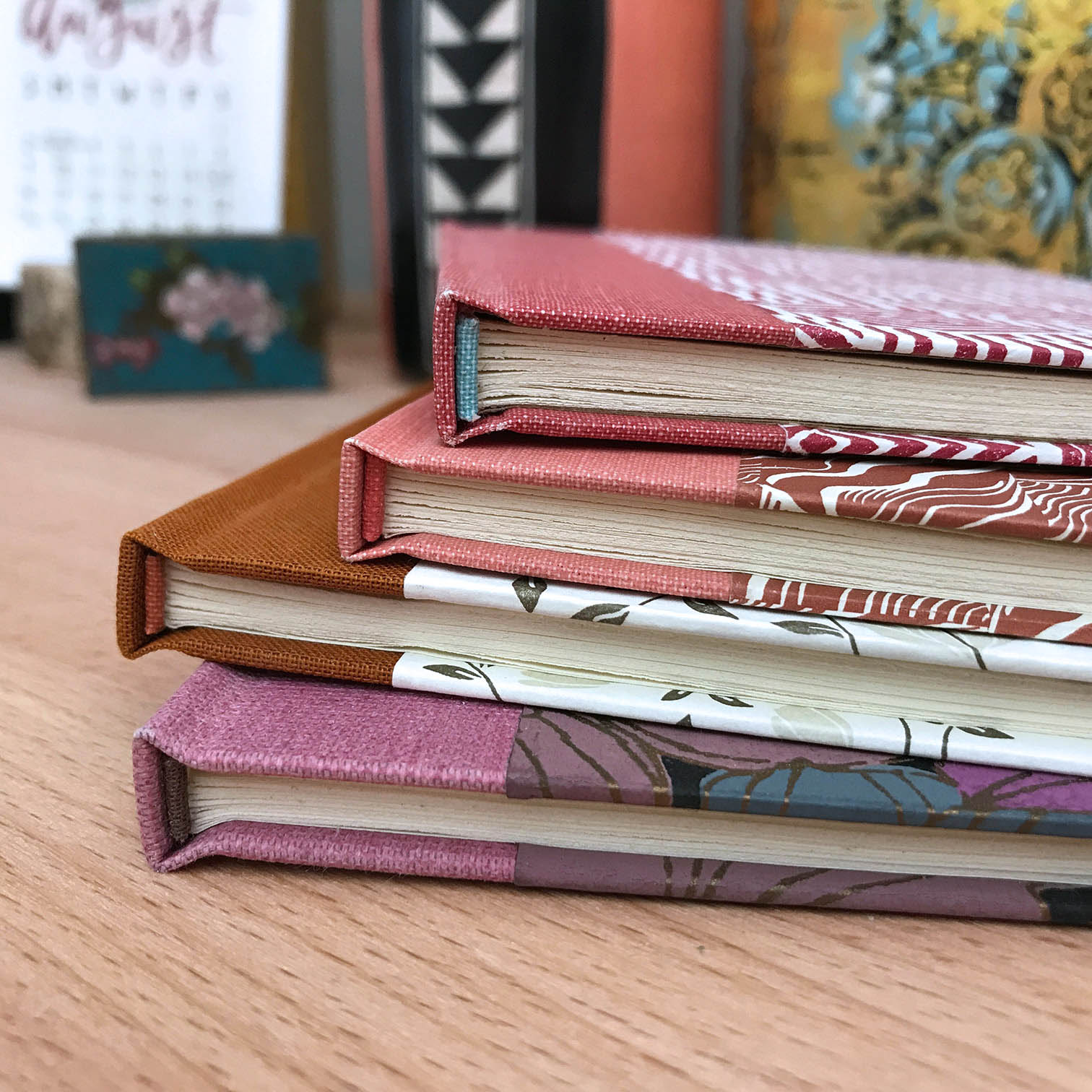 A stack of Flatback Case Bindings on a wooden table.