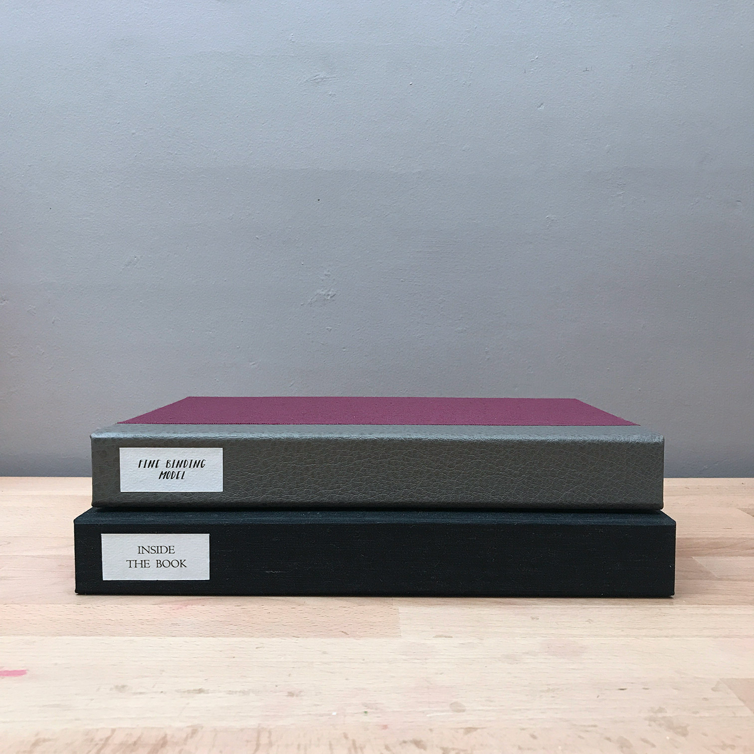 Clamshell boxes stacked on a wooden table.