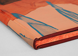 A Rubow-style Millimeter binding laying on a white table top with head edge visible.