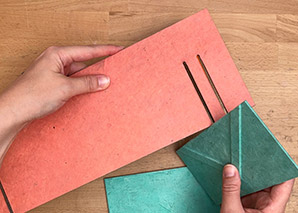 Hands holding two variations of the Cross Structure Binding.